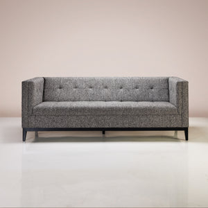 A Cullen Two Seater Sofa upholstered in Staunch Slate fabric, with a solid wood frame and base
