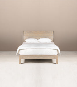 A Juliet Queen Bed made of solid ash wood in semi-lime wash colour