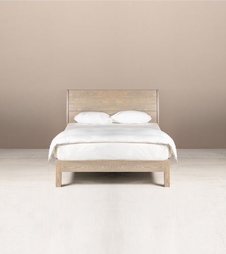A Juliet Queen Bed made of solid ash wood in semi-lime wash colour