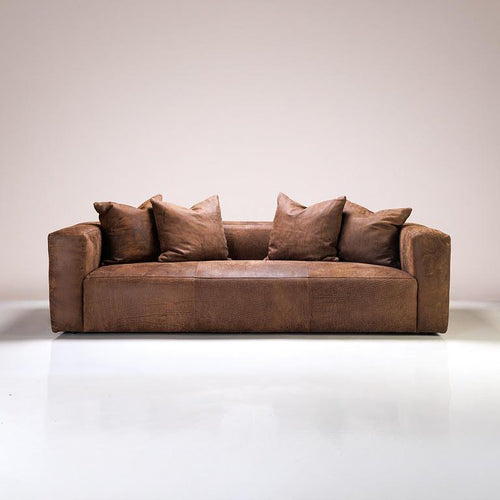 A leather Andromeda sofa in a modern living room setting