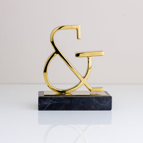 A brass and marble ampersand symbol