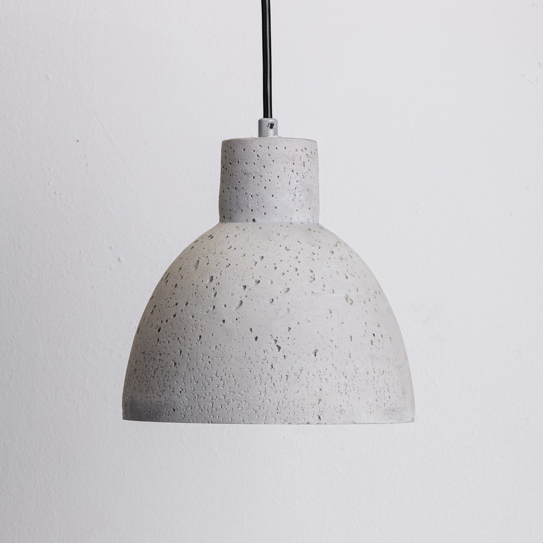 A wide concrete pendant light