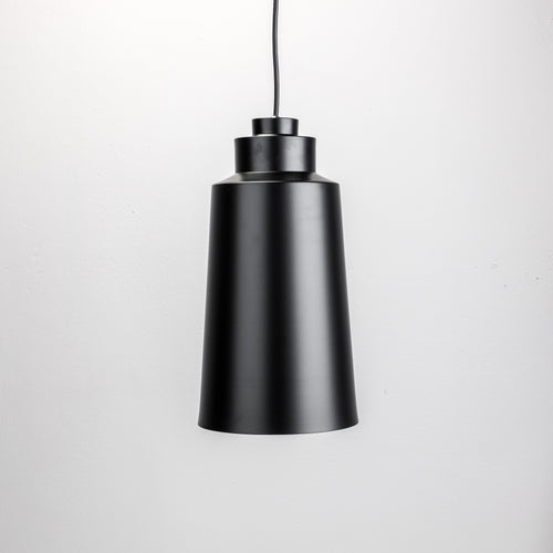 A black bell-shaped pendant lamp hanging from the ceiling