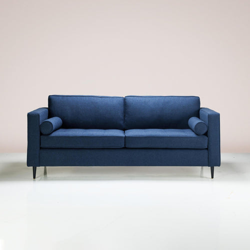 A Bolster Sofa upholstered in midnight-colored fabric