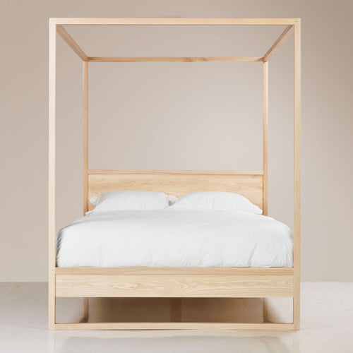 A Copenhagen Four Poster Bed made of solid ash wood with a semi-lime wash colour