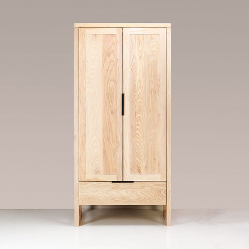 A Copenhagen Wardrobe made of solid ash wood with a semi-lime wash colour