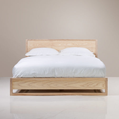 A Copenhagen Bed in Queen XL size, made of solid ash wood with a semi-limewash colour